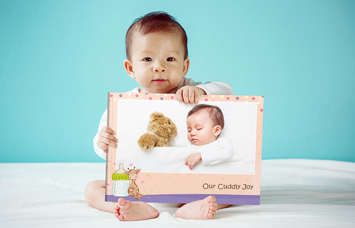 Design a baby's first-year photo book/scrapbook full of cuddling memories